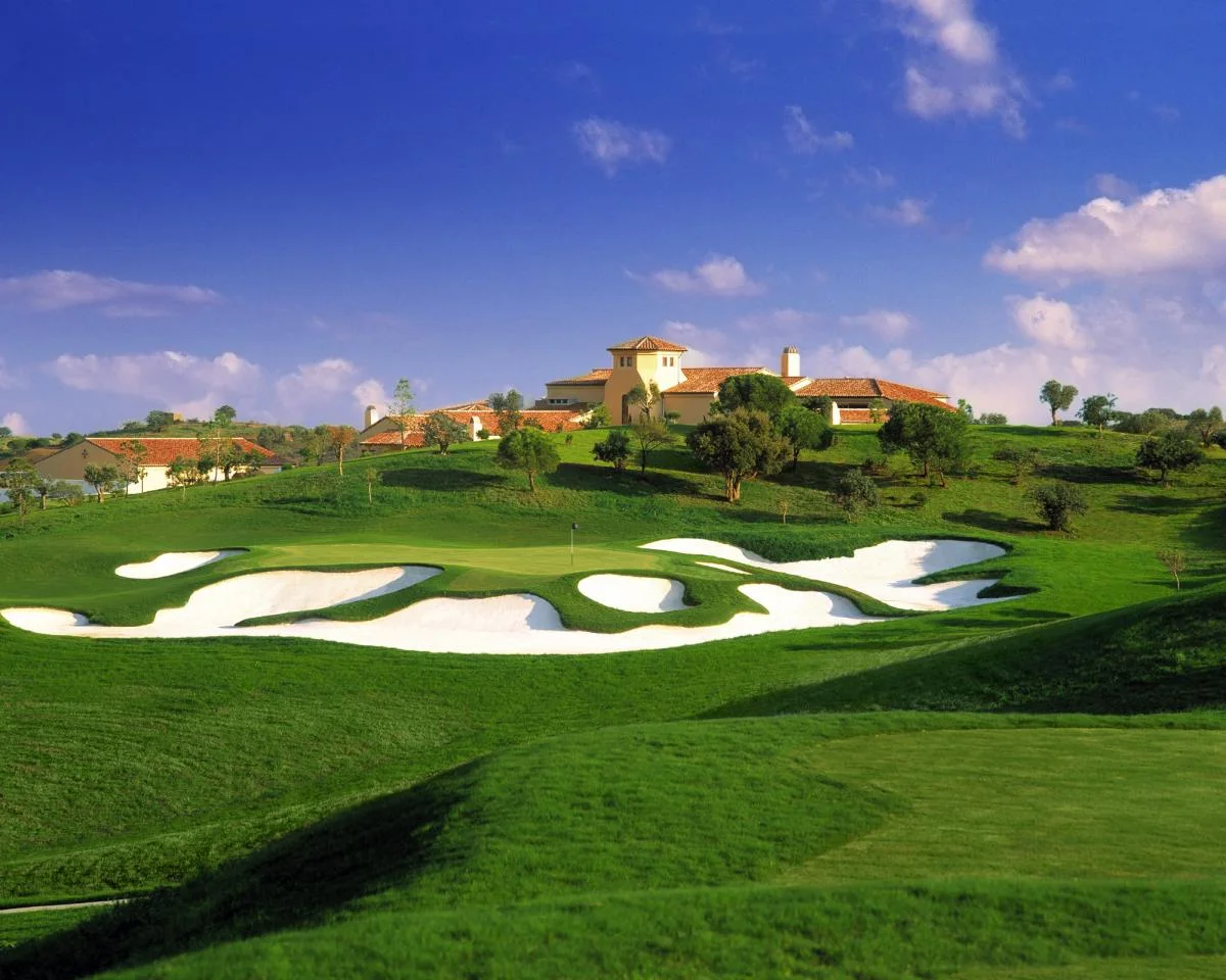 Fairway and sculpted bunkers on the approach towards the Monte Rei clubhouse