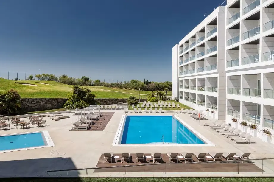 Crowne Plaza Caparica · outdoor pool and hotel